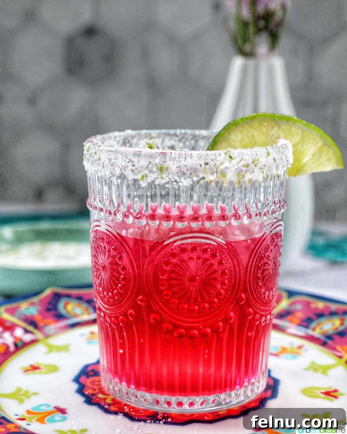 Desert Bloom Margarita 2 Glass of vibrant prickly pear margarita garnished with a fresh lime slice.