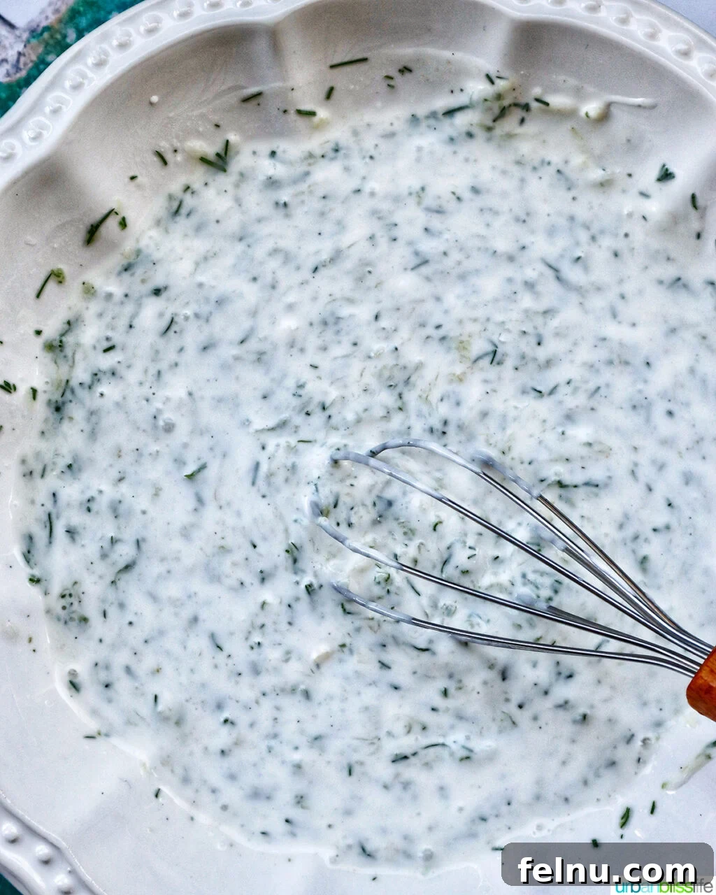 Cool & Creamy Tzatziki Chicken Salad 6 Step 2: Shredded chicken, diced red onion, and chopped kalamata olives are added to a large mixing bowl.