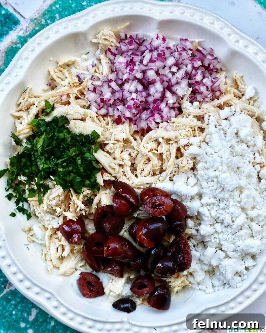 Cool & Creamy Tzatziki Chicken Salad 8 Step 4: The Tzatziki Chicken Salad is fully mixed, showcasing its creamy texture and colorful ingredients.