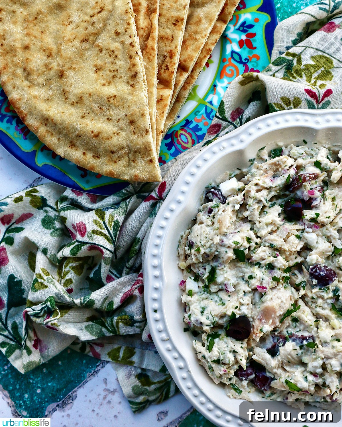 Cool & Creamy Tzatziki Chicken Salad 10 bowl of chicken tzatziki salad with side of pita bread, ready to be enjoyed.