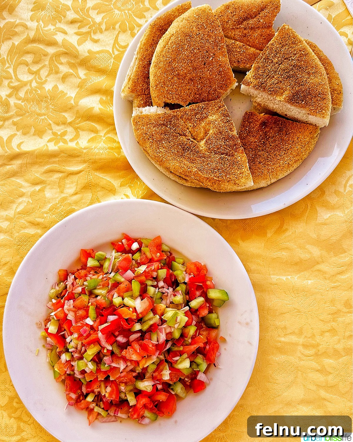Authentic Moroccan Cuisine 12 Moroccan Khobz bread served with a tomato and cucumber salad.