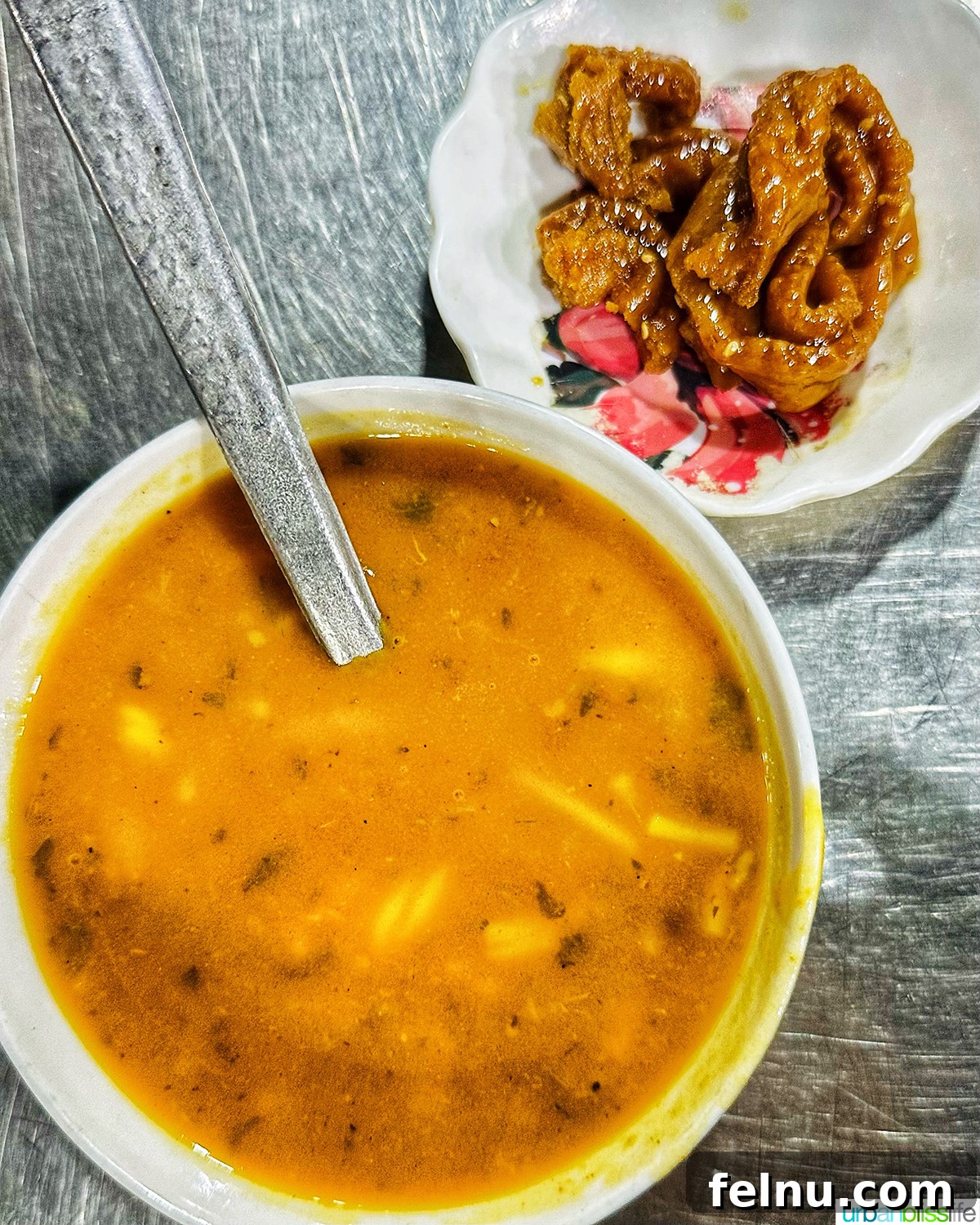 Authentic Moroccan Cuisine 7 A bowl of steaming Harira soup with Chebakia pastry.