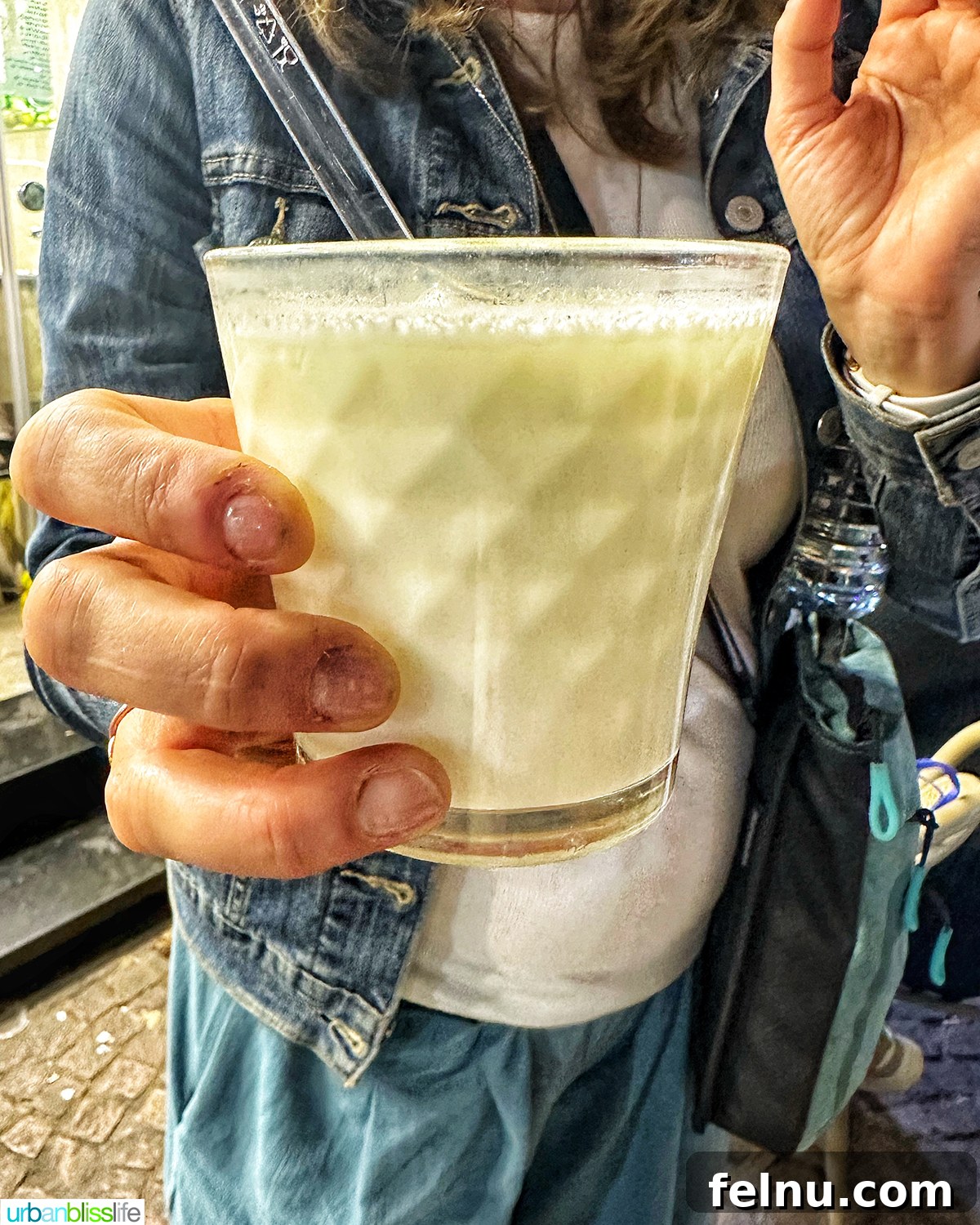 Authentic Moroccan Cuisine 8 A hand holding a cup of Moroccan Raib yogurt.