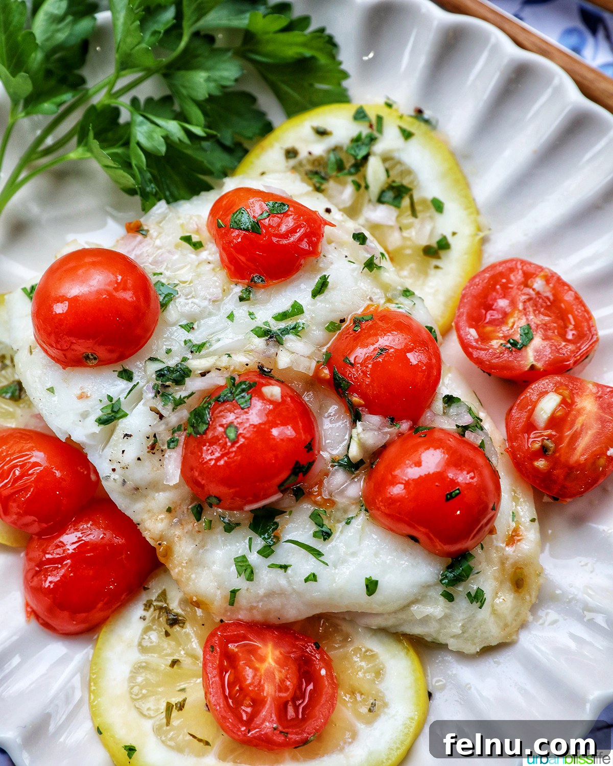 Flaky Cod En Papillote 2 Cod en Papillote on a plate with fresh herbs, showcasing the vibrant colors of the dish.