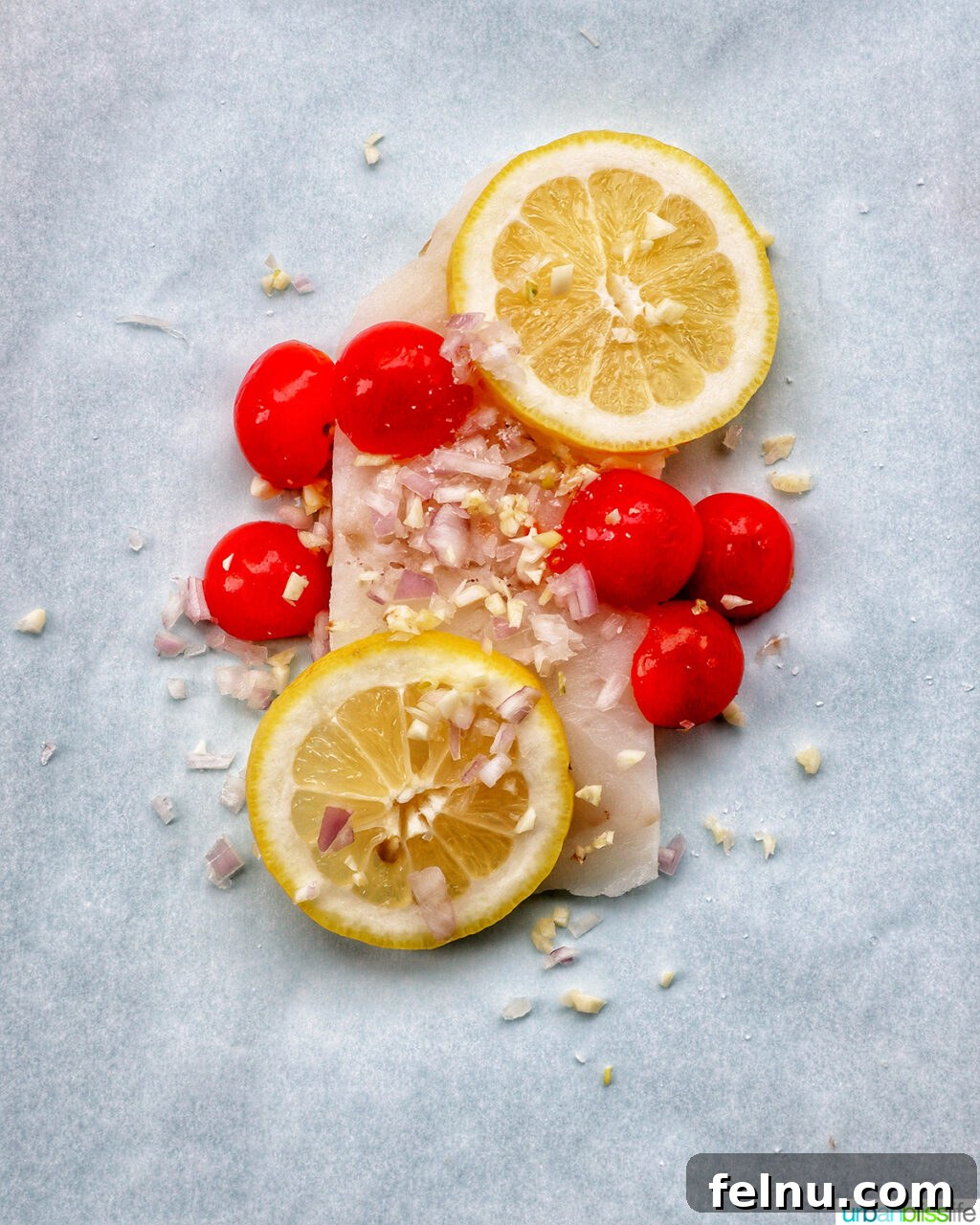 Flaky Cod En Papillote 6 Cod fillet covered with cherry tomatoes, shallots, minced garlic, and lemon slices.