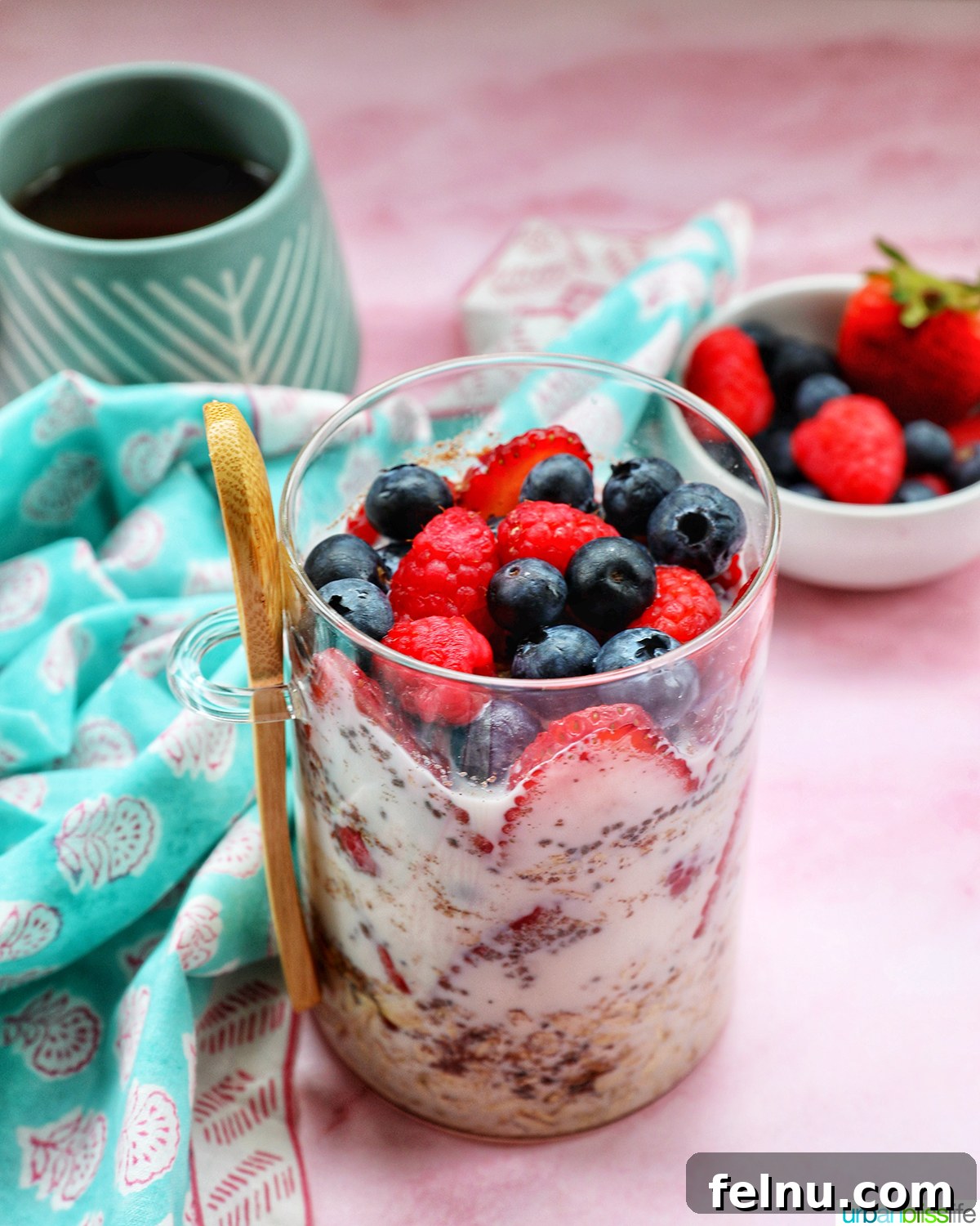 Overnight Berry Bliss 3 Close-up of Berry Overnight Oats in a mason jar, with a cup of coffee and a spoon, highlighting a perfect morning.