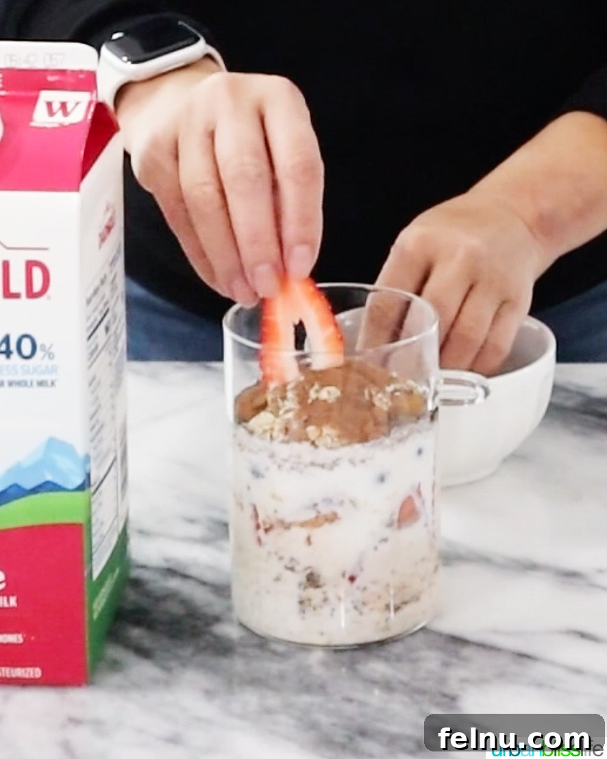 Overnight Berry Bliss 7 Step 3: Topping the overnight oats mixture with a generous layer of fresh berries.