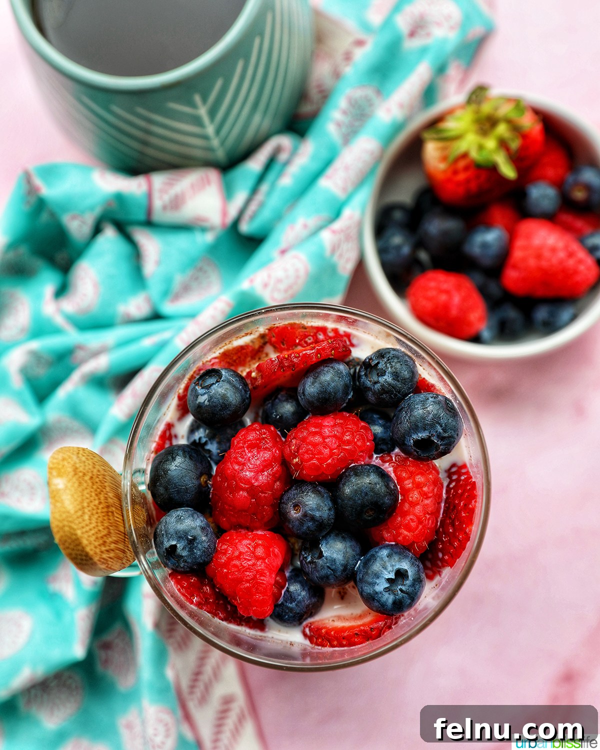 Overnight Berry Bliss 9 Overhead shot of Berry Overnight Oats in a mason jar with a spoon, highlighting the colorful layers and inviting texture.