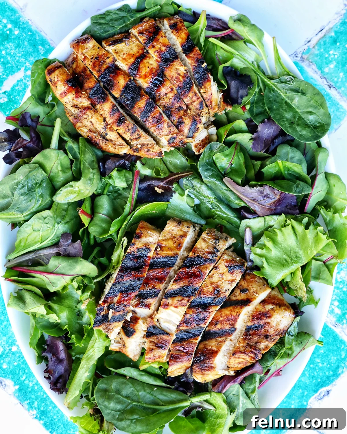 Tangy Balsamic Chicken Greens 11 A prepared salad with mixed greens and sliced chicken, waiting for additional toppings.