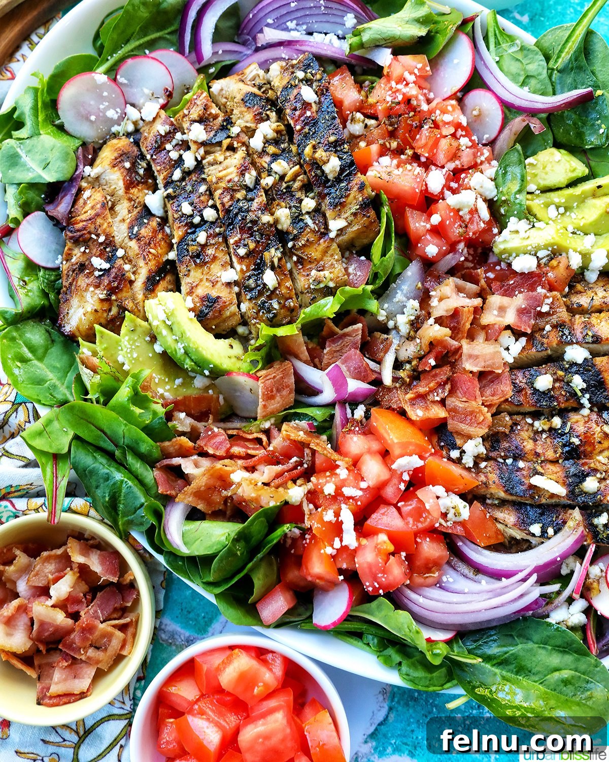 Tangy Balsamic Chicken Greens 13 A complete Balsamic Chicken Salad with bowls of cherry tomatoes and bacon crumbles for garnishing.
