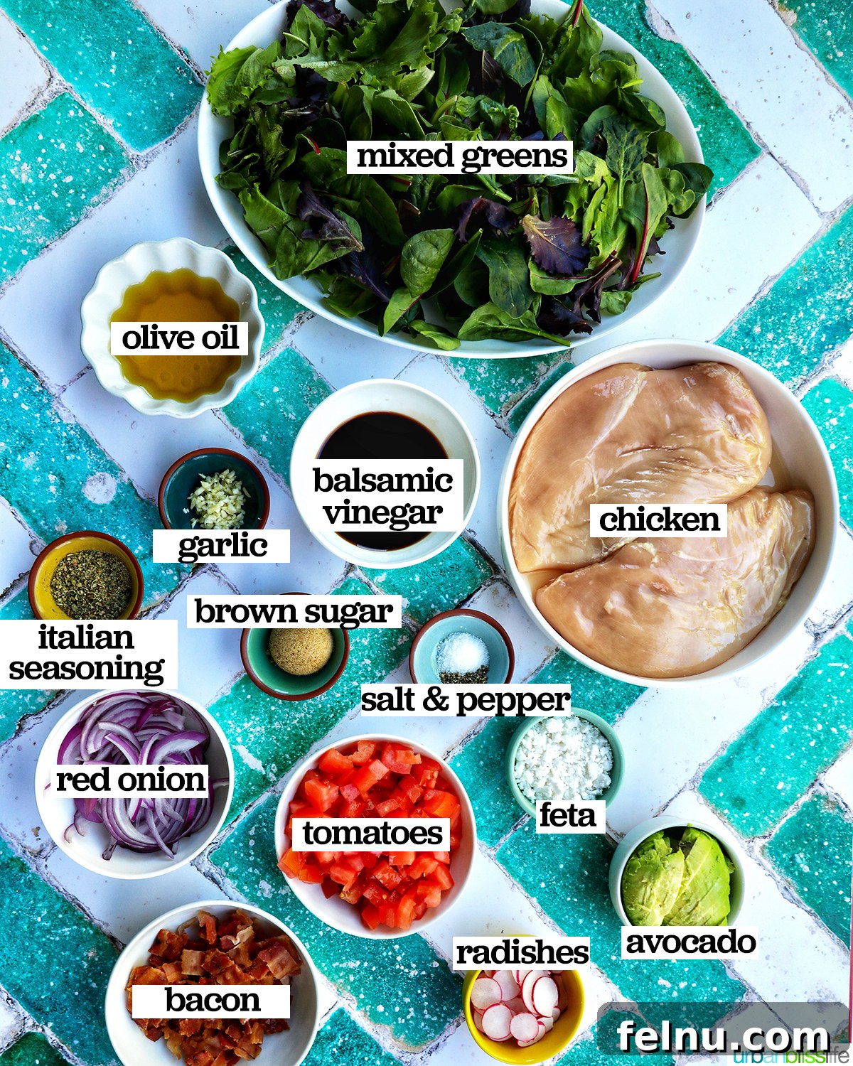 Tangy Balsamic Chicken Greens 4 Bowls filled with fresh ingredients for Balsamic Chicken Salad, including sliced chicken breast, mixed greens, cherry tomatoes, red onion, avocado, feta, and a jar of balsamic dressing.