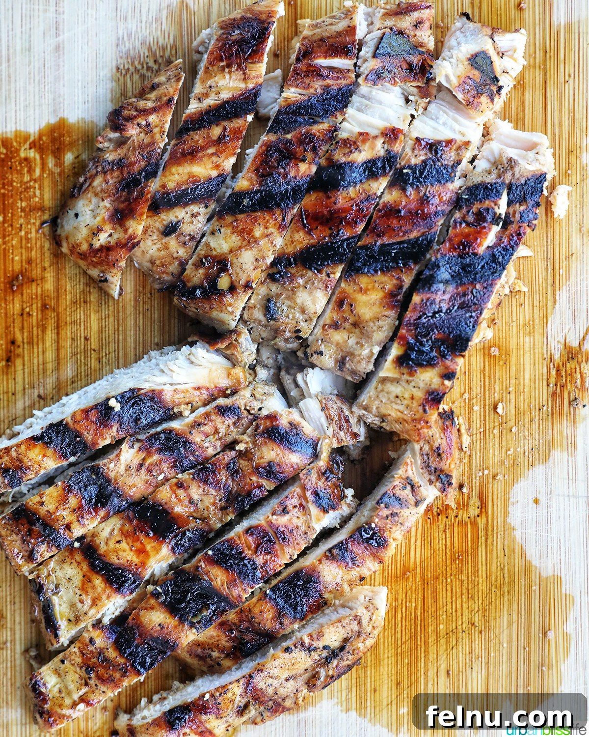 Tangy Balsamic Chicken Greens 9 Perfectly grilled chicken sliced on a cutting board, ready to be added to the salad.