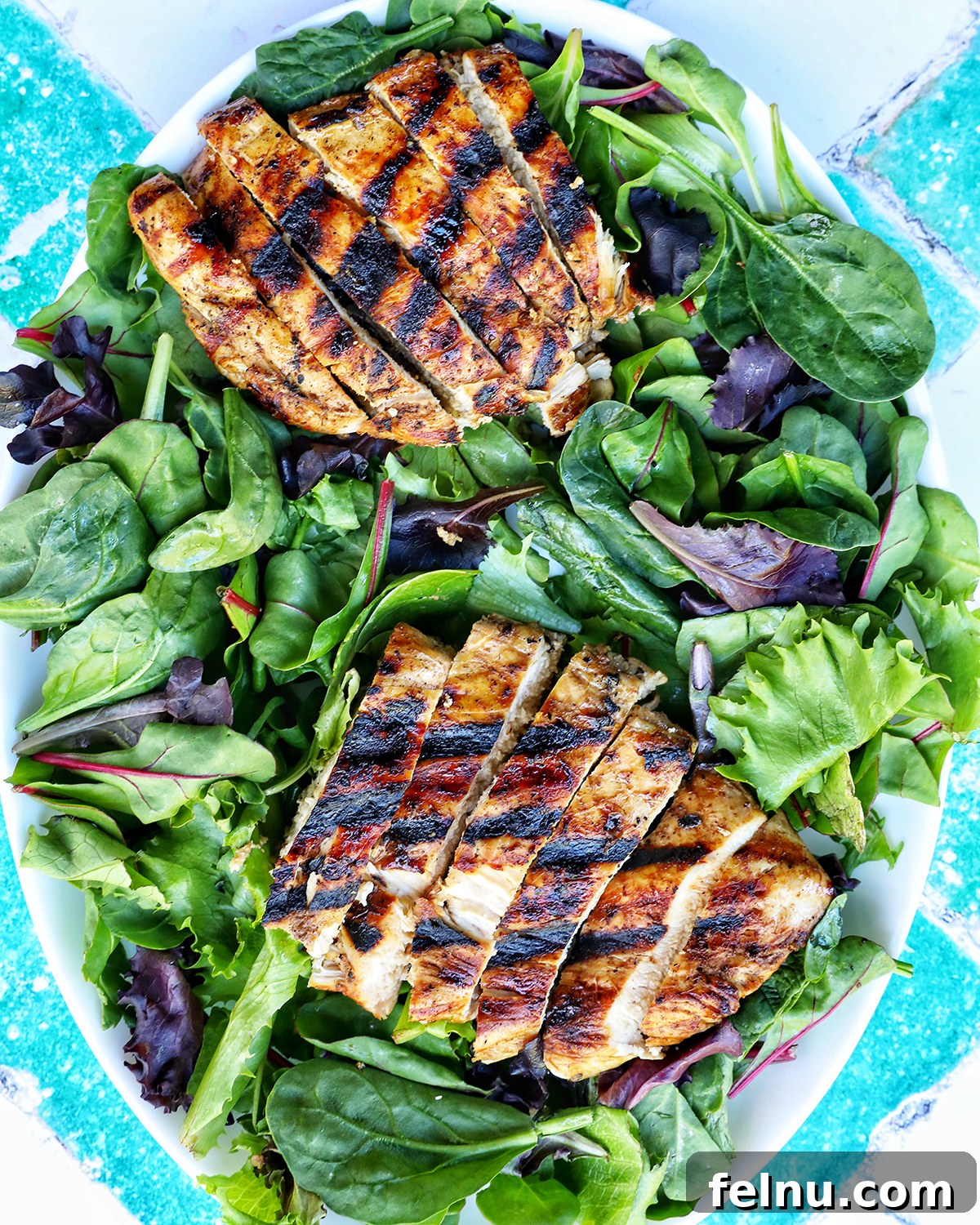 Tangy Balsamic Chicken Greens 10 Sliced grilled chicken arranged beautifully on a bed of fresh mixed greens.