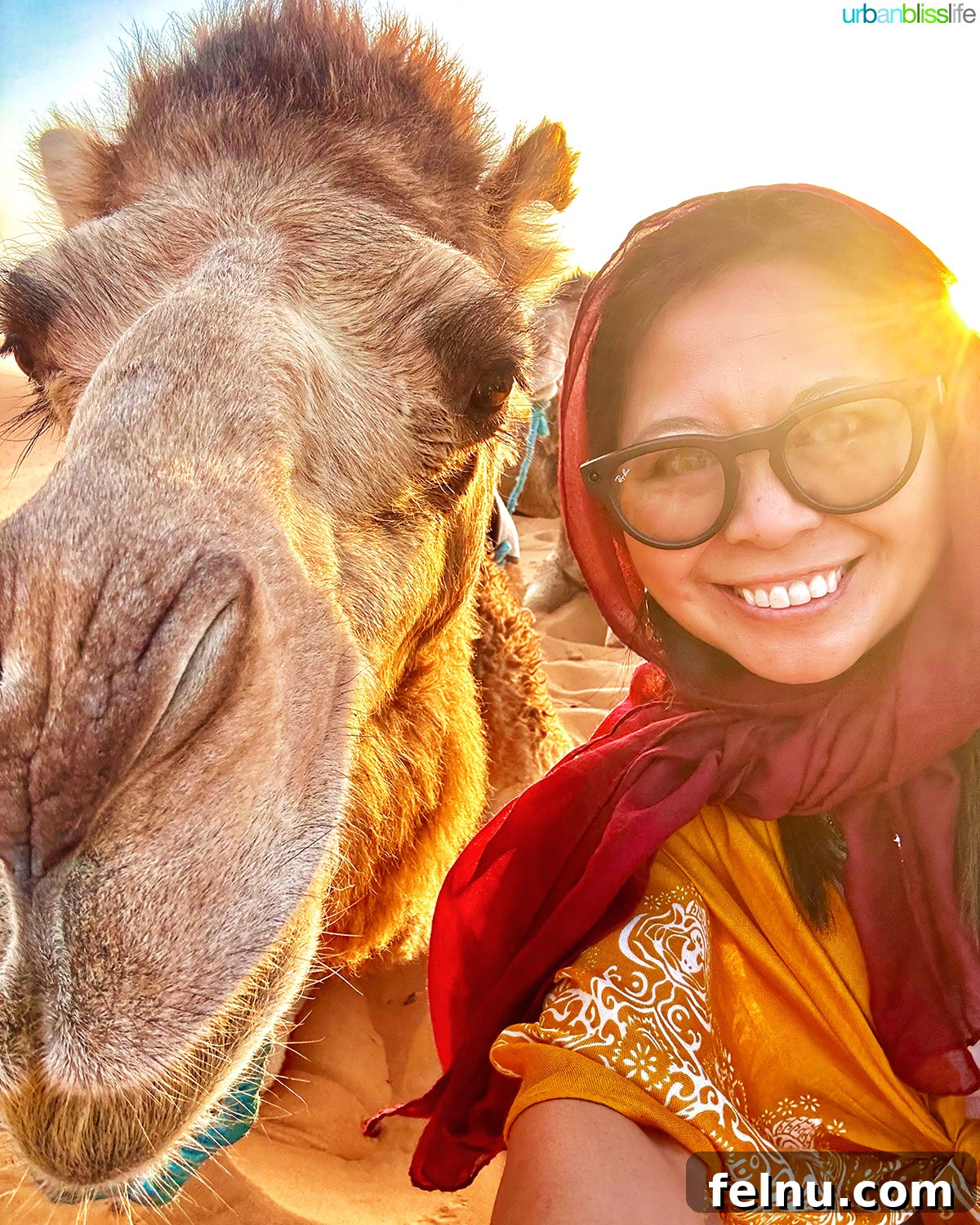 Morocco's Sahara Desert Adventure Guide 13 Marlynn Jayme Schotland posing next to a camel in the vast Sahara Desert in Morocco.