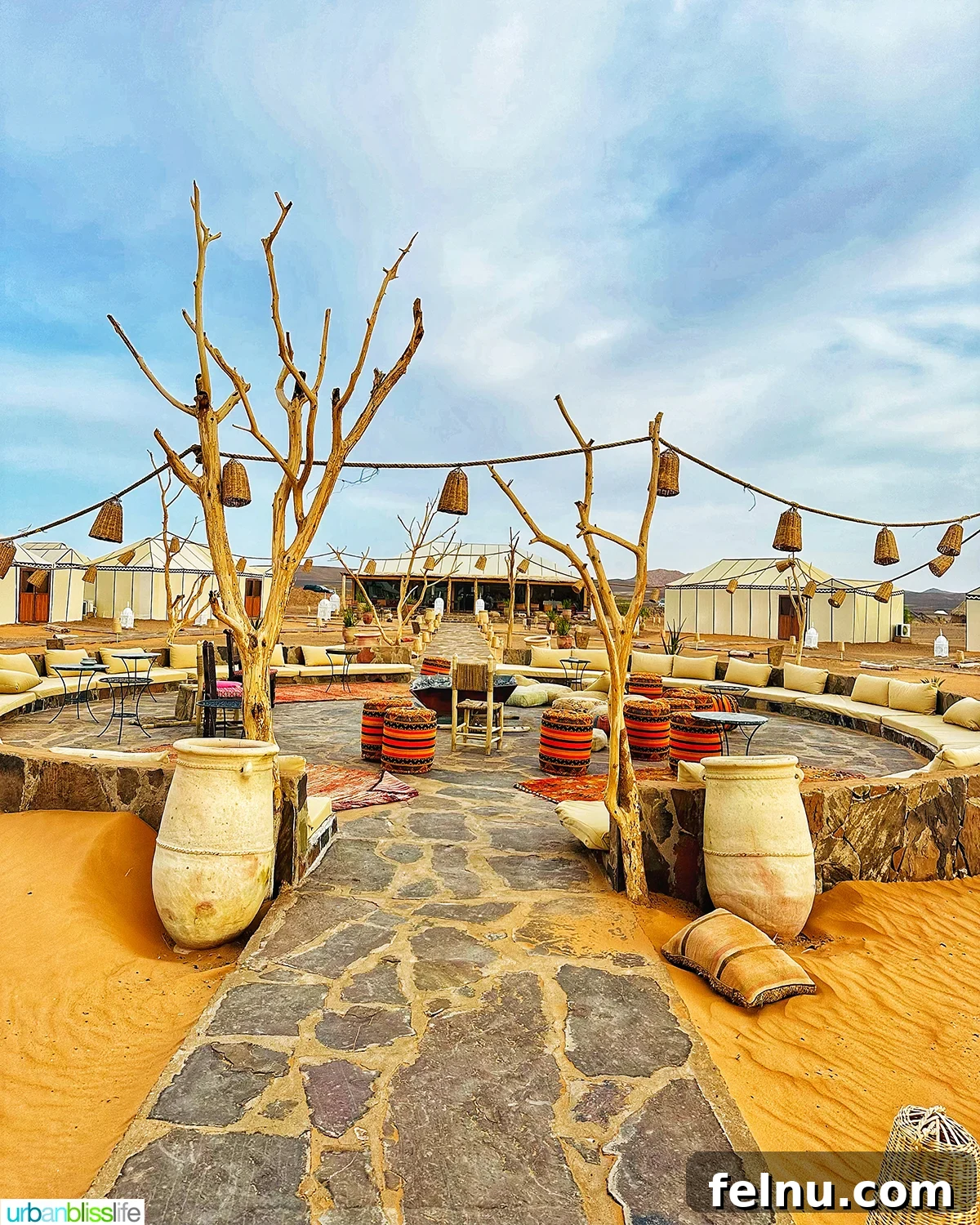 Morocco's Sahara Desert Adventure Guide 14 A luxury desert camp setting with comfortable seating and lanterns in the Sahara Desert in Morocco.