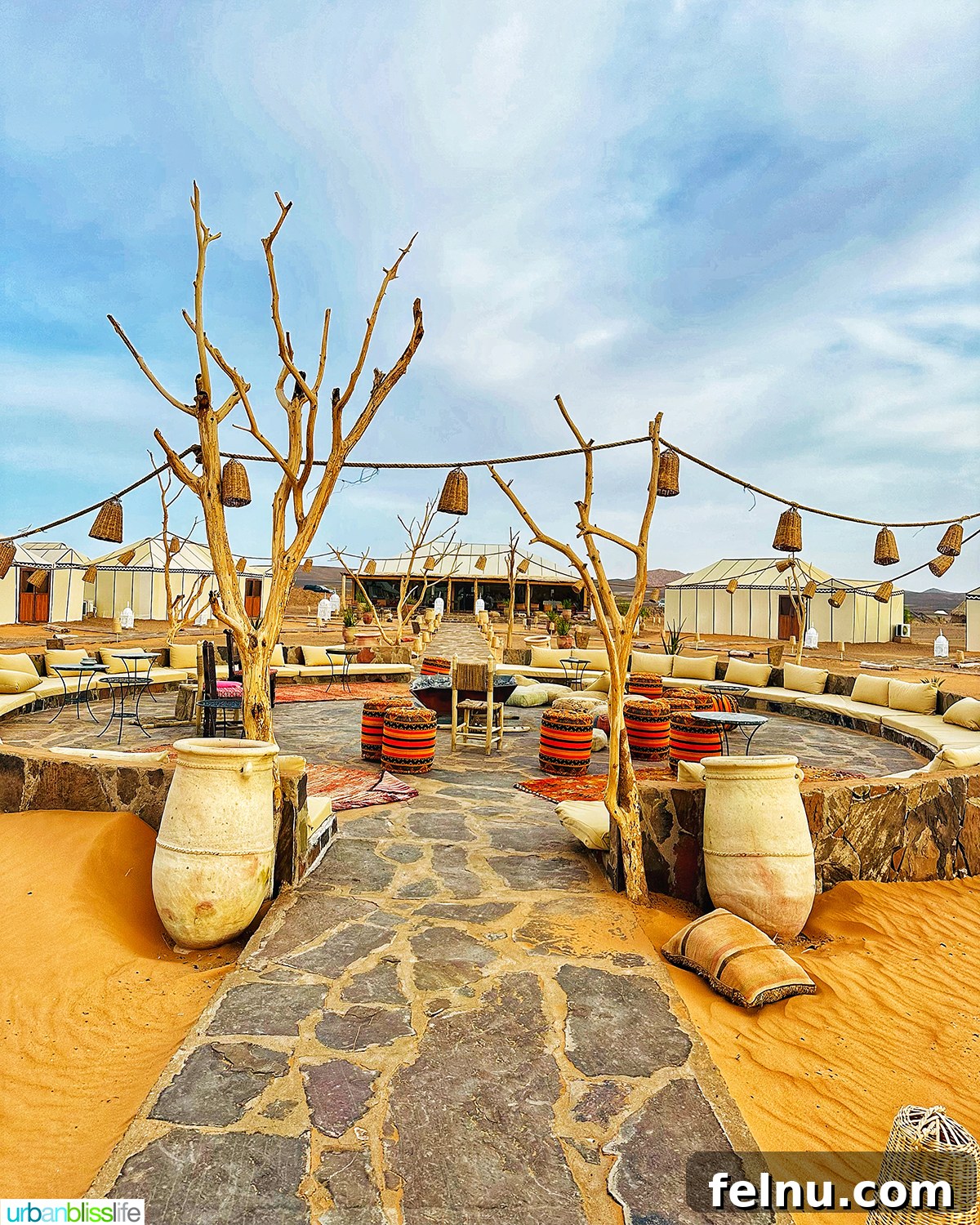 Morocco's Sahara Desert Adventure Guide 5 A luxurious desert camp setting with comfortable seating and lanterns in the Sahara Desert in Morocco.