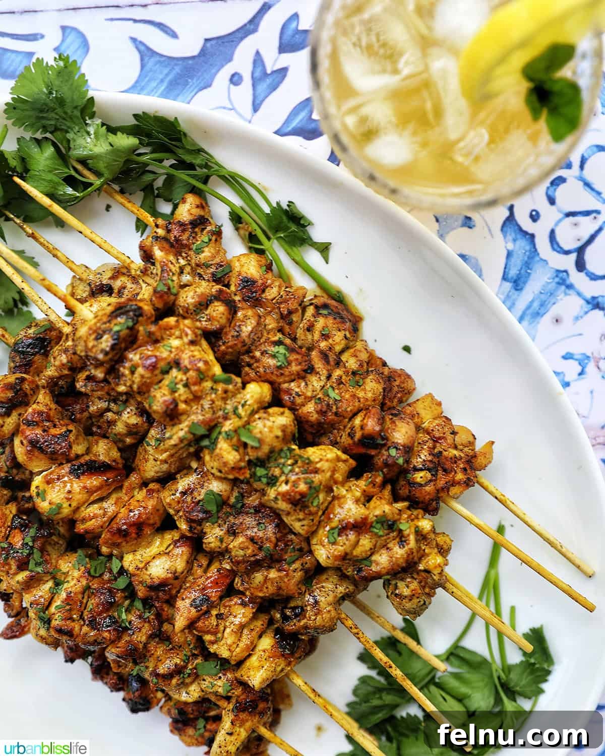 Tandoori Chicken Kebabs 17 Tandoori chicken skewers with glass of bourbon lemonade.