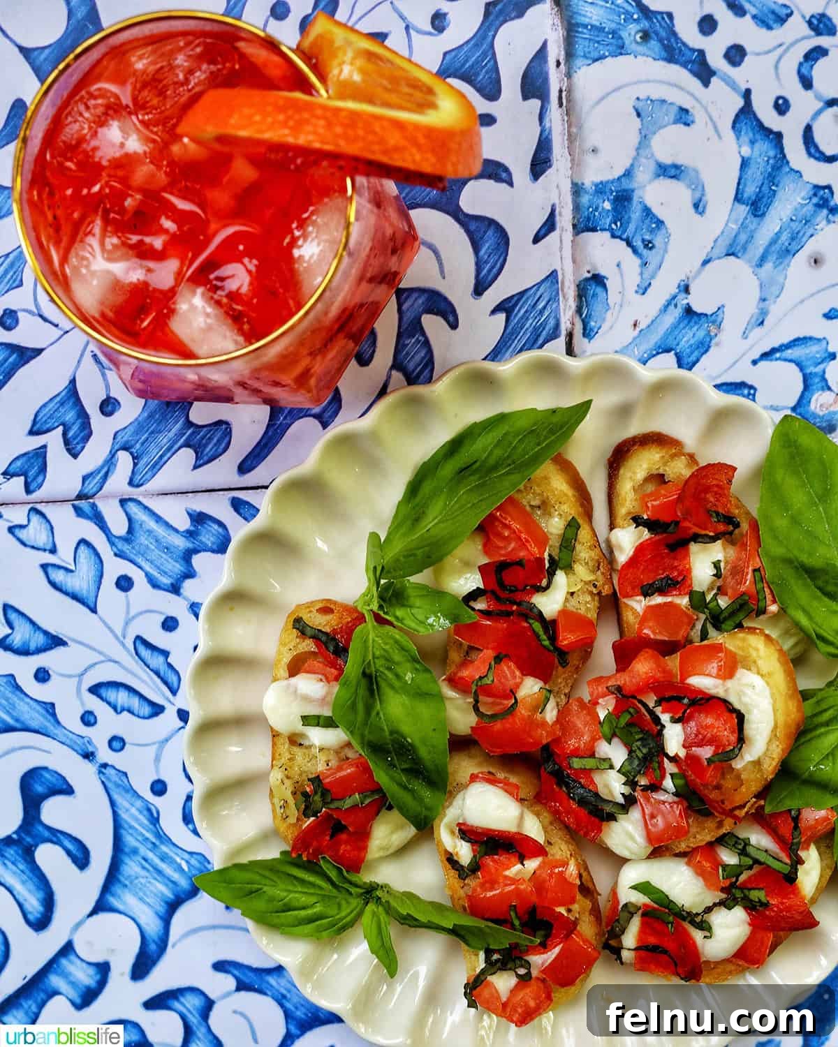 Strawberry Spritz served with a plate of crostini pizza.