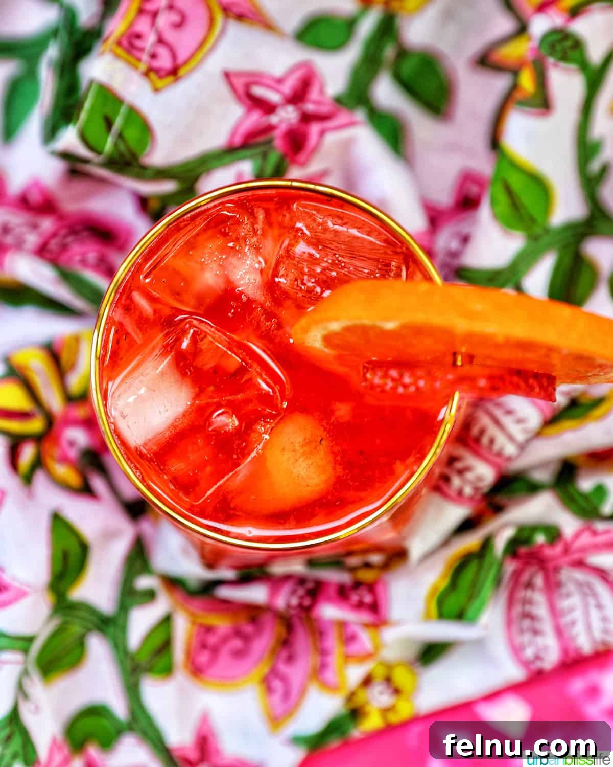 Overhead shot of a Strawberry Spritz with orange and strawberry garnish.