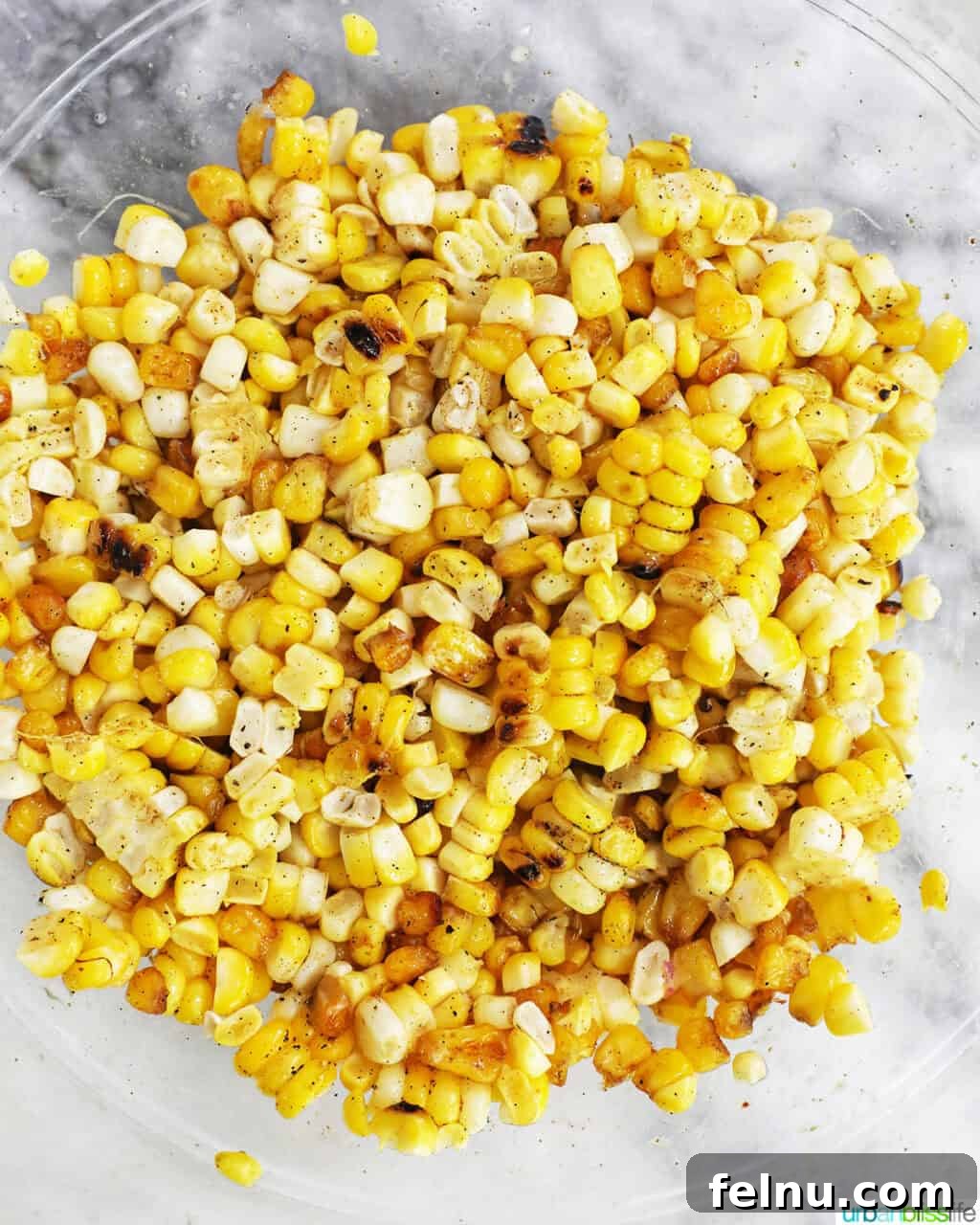 Fire-Kissed Corn Salad 9 Bowl filled with freshly cut charred corn kernels.