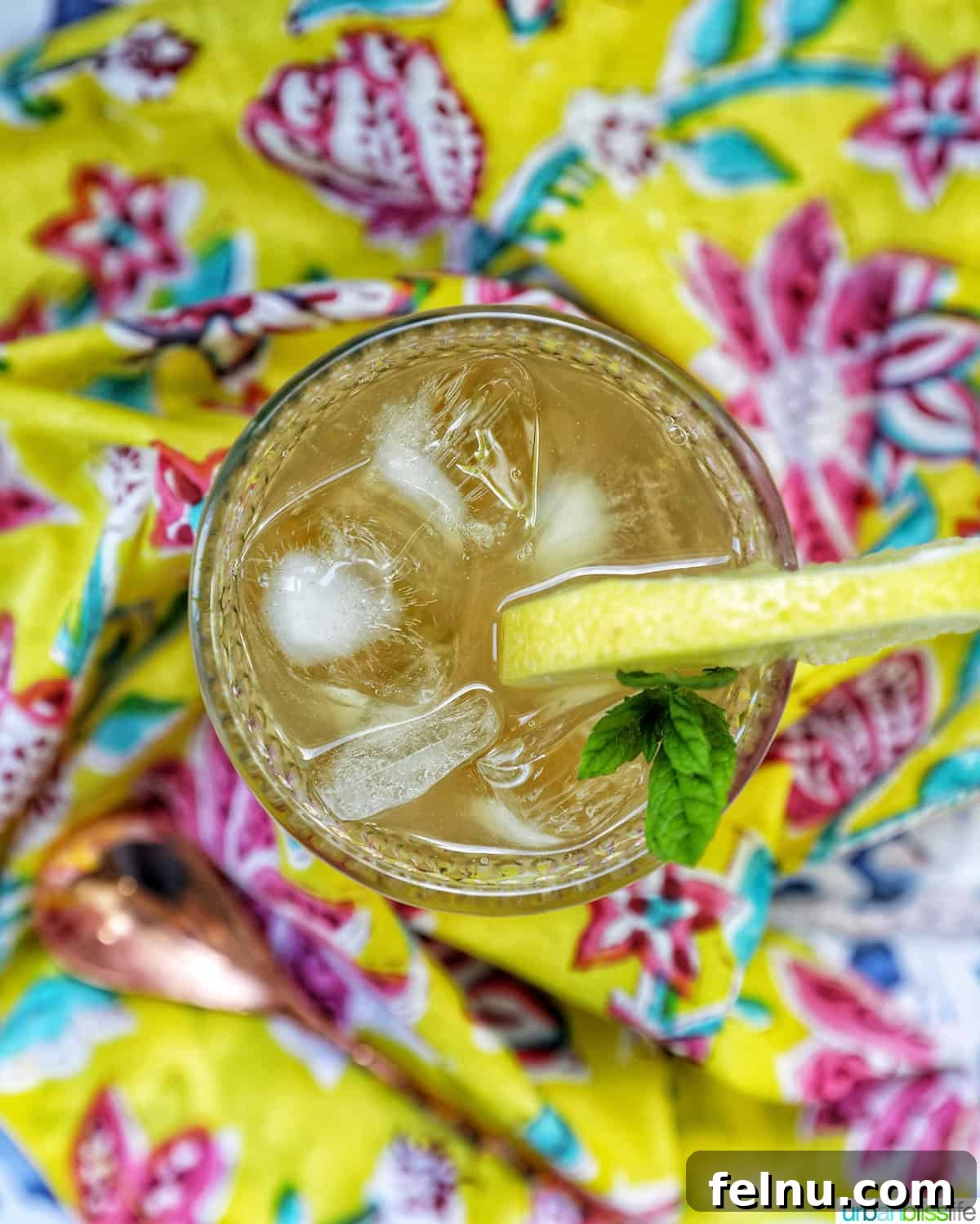 Bourbon Bliss: A Zesty Lemonade Twist 3 Overhead view of a glass of refreshing bourbon lemonade on a bright, colorful napkin.