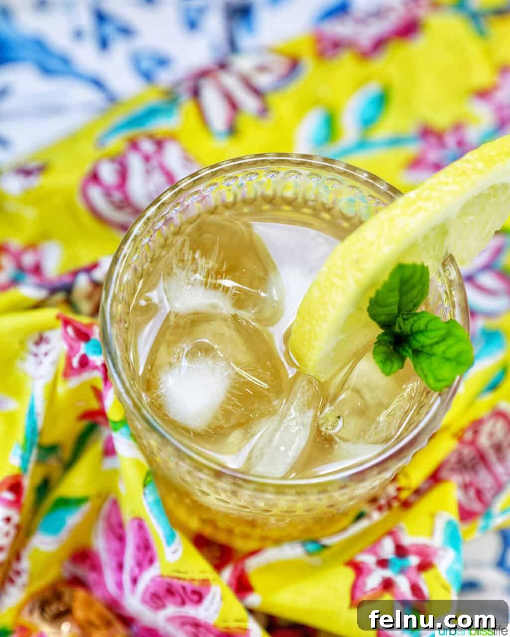 Bourbon Bliss: A Zesty Lemonade Twist 5 A beautifully prepared glass of bourbon lemonade on a bright, vibrant napkin.