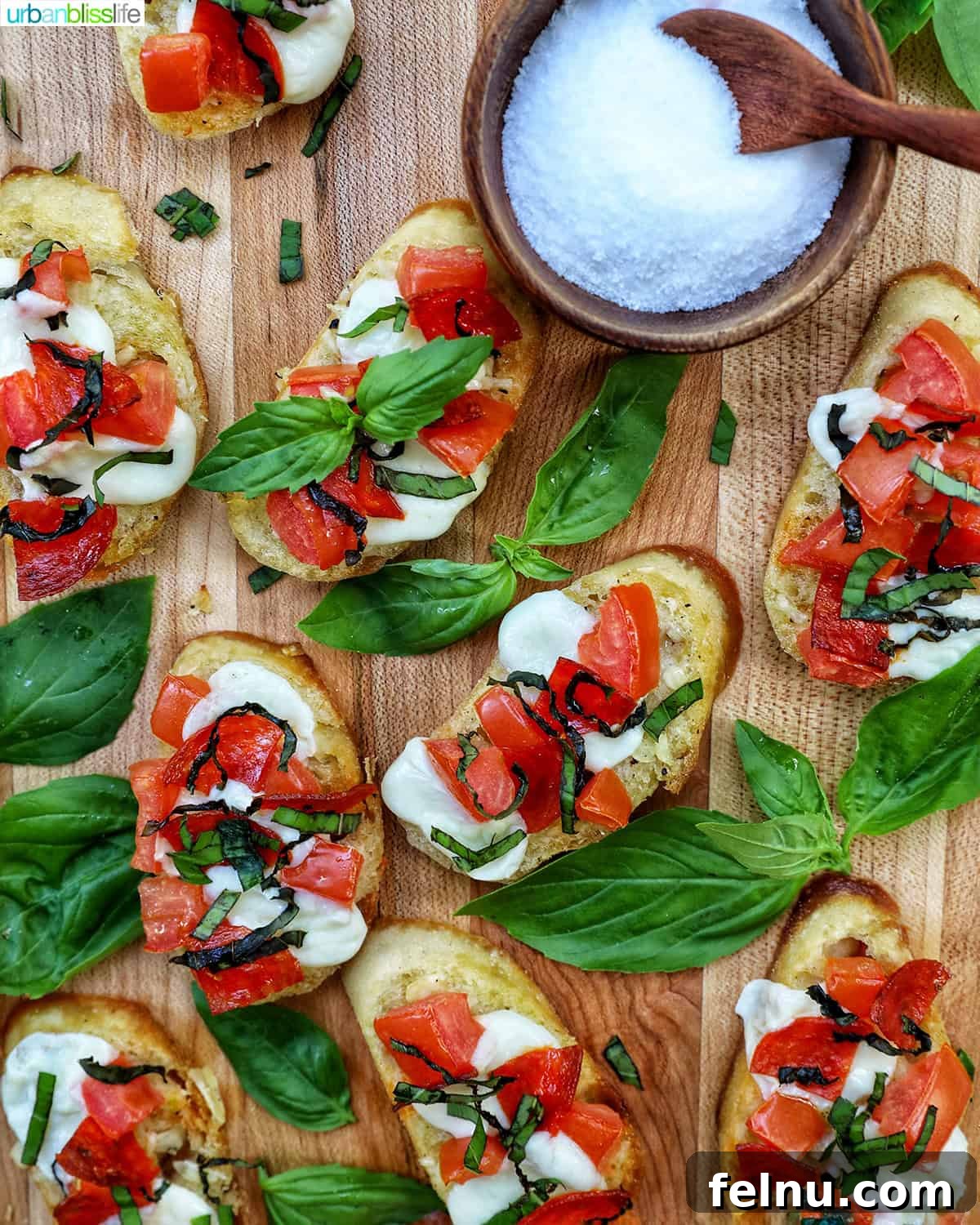 A platter of beautiful, fresh crostini pizzas with a sprinkle of salt.