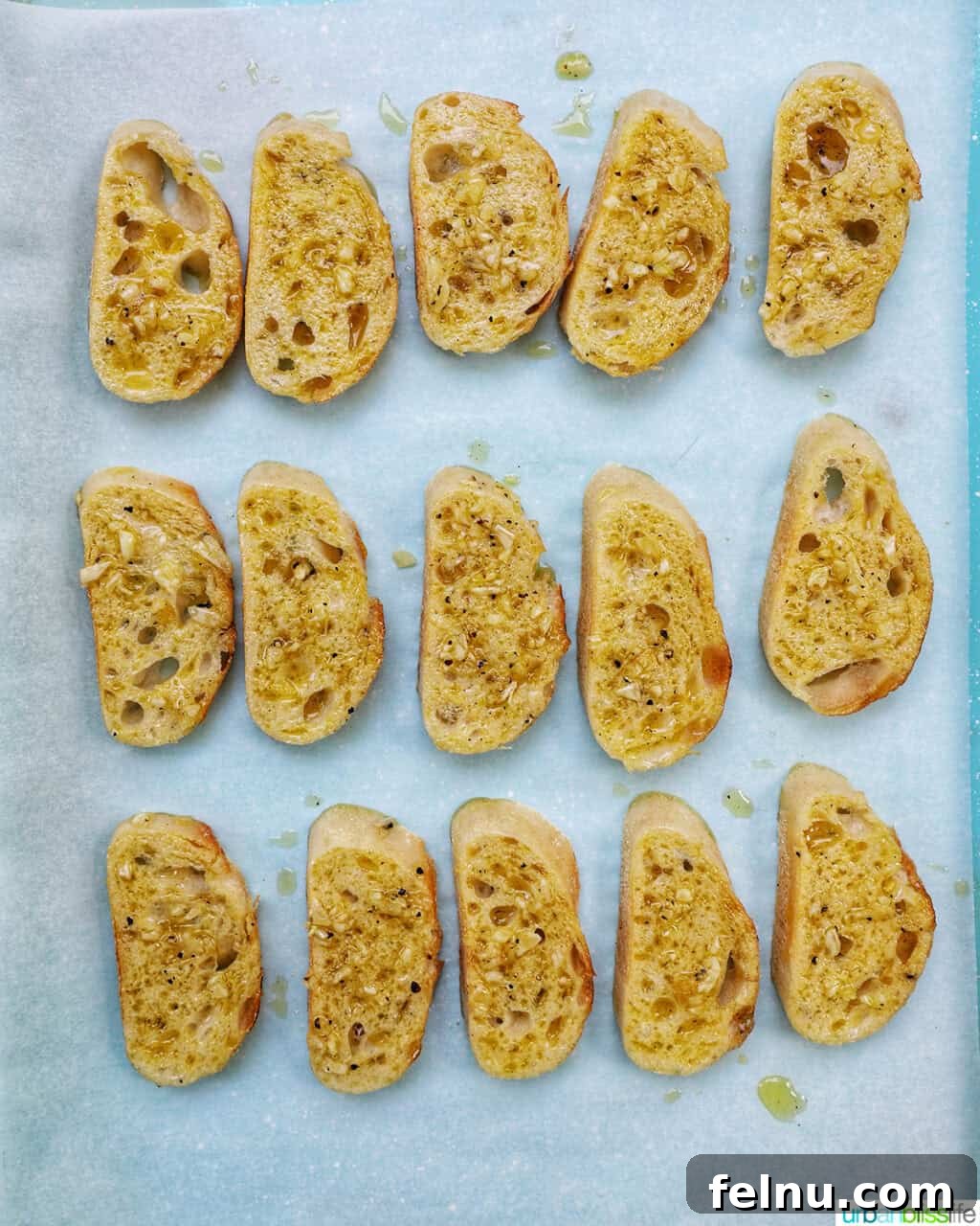 Sliced crostini arranged on a baking sheet.