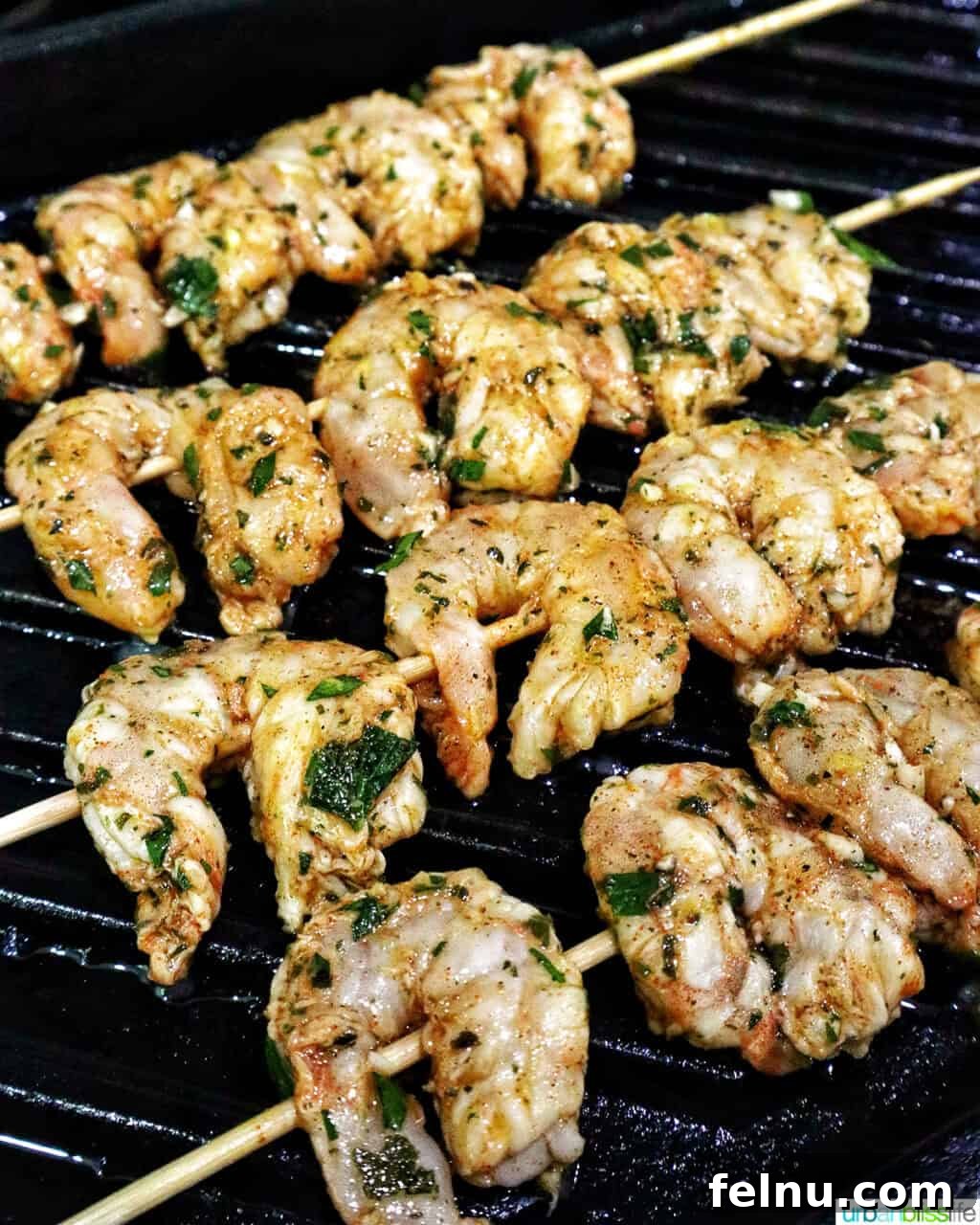 Grilled Shrimp Skewers with Chili-Lime Glaze 7 Prawn BBQ Skewers grilling on a grill pan, developing a beautiful char.