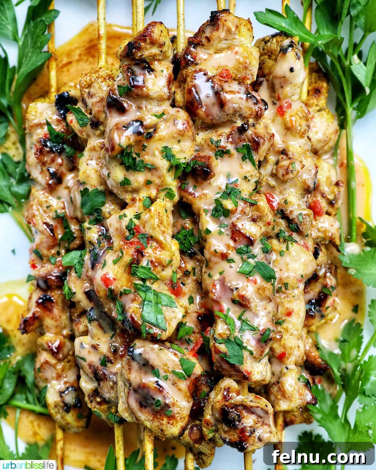 Spicy Peanut Glazed Chicken Skewers 2 Bang Bang Chicken Skewers served on a plate with fresh herb garnish, ready to be enjoyed.