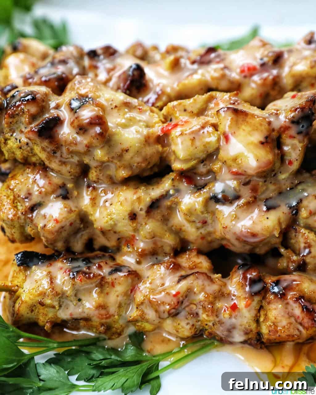 Spicy Peanut Glazed Chicken Skewers 13 A close-up shot of grilled chicken skewers generously coated with Bang Bang sauce.