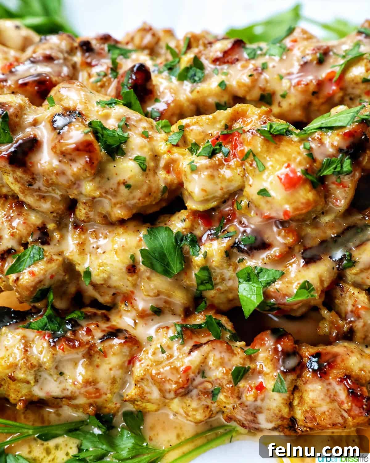 Spicy Peanut Glazed Chicken Skewers 14 A beautifully plated stack of finished Bang Bang Chicken Skewers, showing the delicious coating of sauce and garnish.