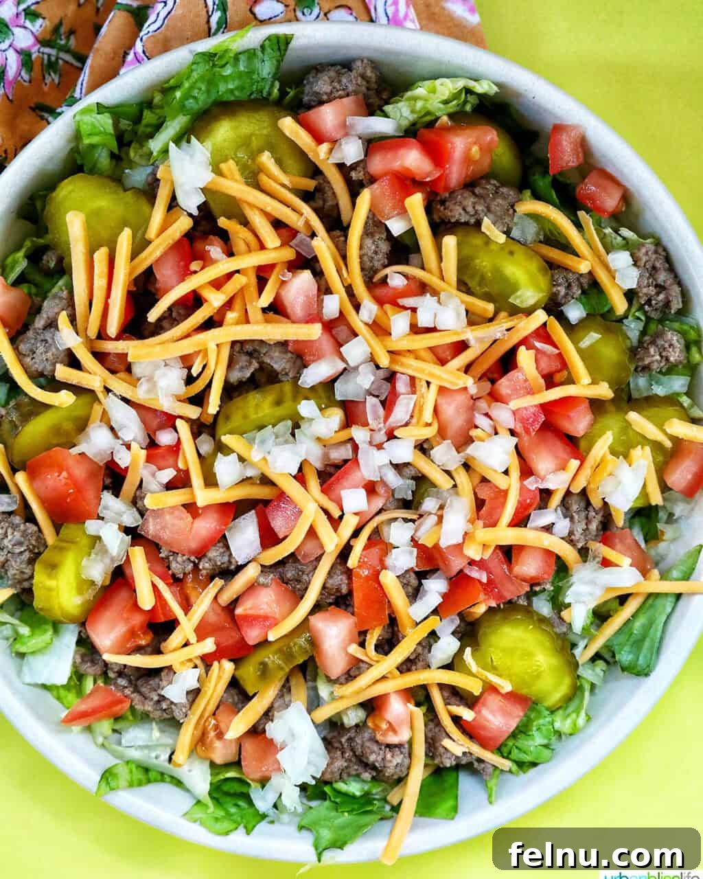 Big Mac Burger Bowl 12 Adding chopped tomatoes and pickles to a Big Mac salad bowl.