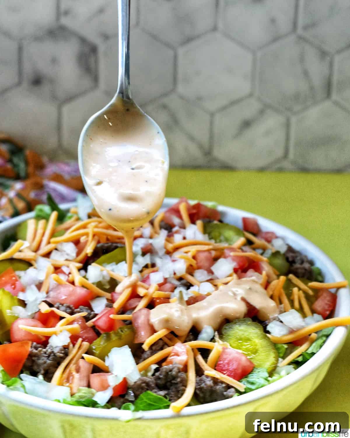 Big Mac Burger Bowl 14 Close-up of Big Mac Salad dressing in a bowl with a spoon.