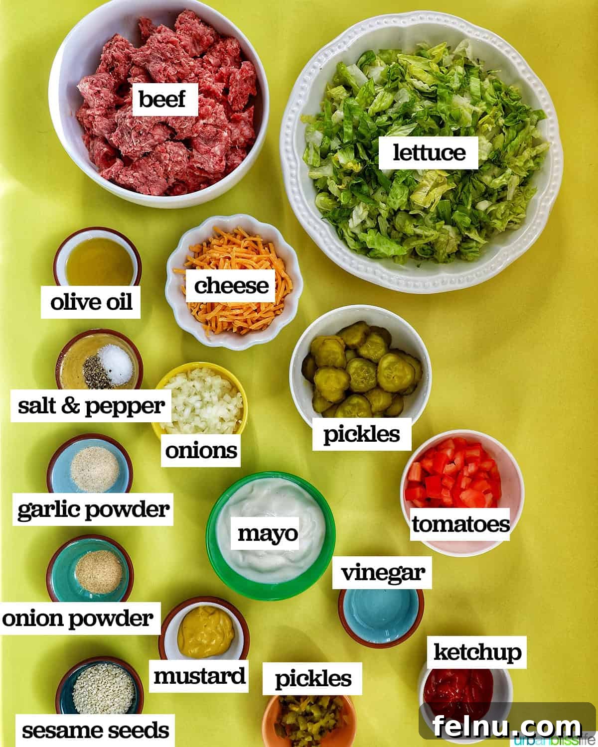 Big Mac Burger Bowl 4 A selection of fresh ingredients laid out, including ground beef, lettuce, cheese, pickles, tomatoes, onions, and the components for Big Mac sauce.