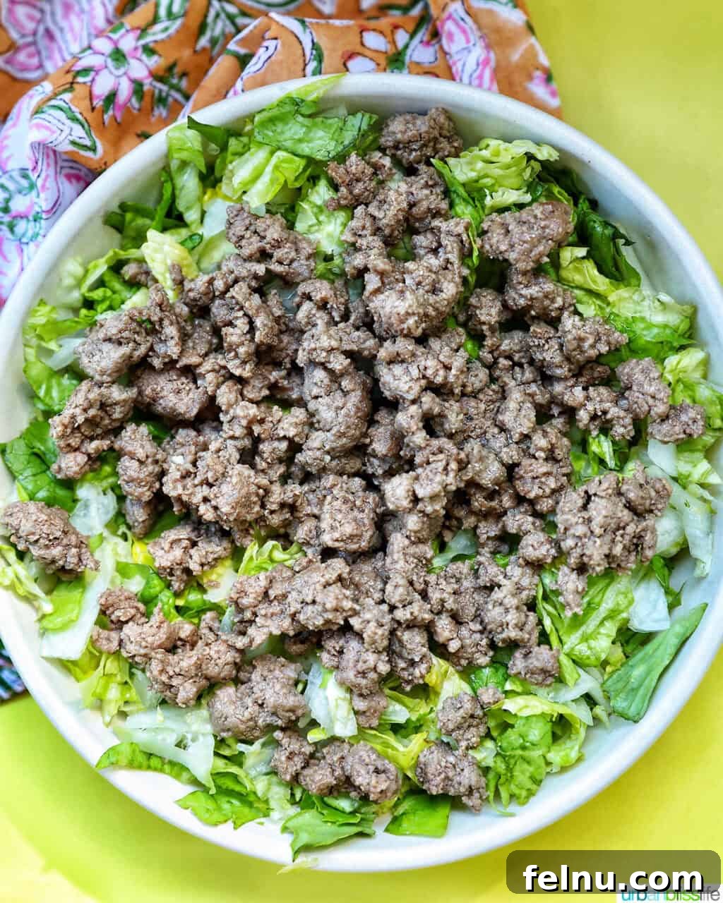 Big Mac Burger Bowl 9 Layering chopped lettuce in a large salad bowl.