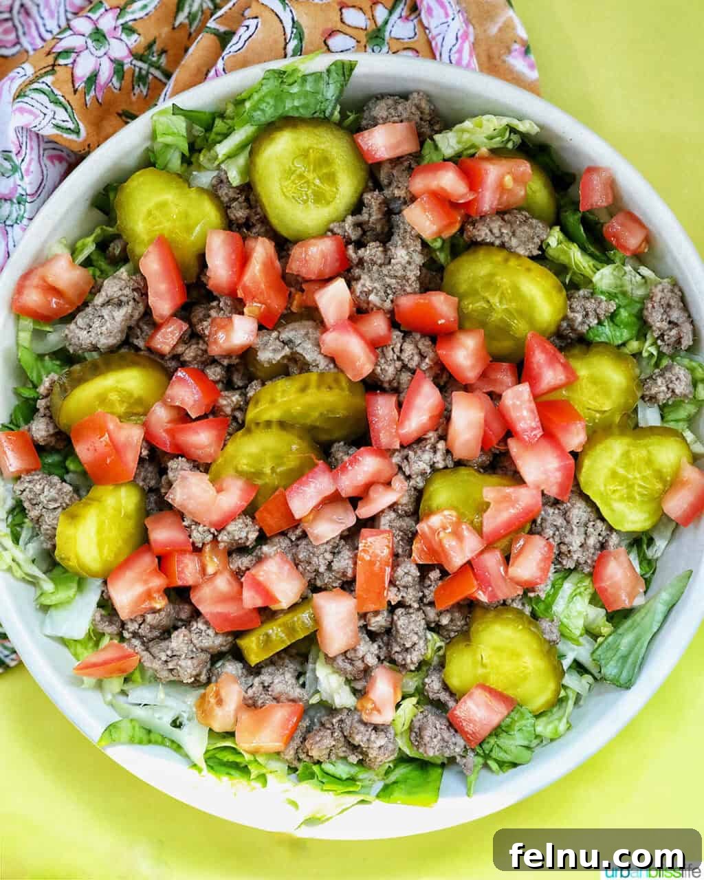Big Mac Burger Bowl 10 Adding cooked ground beef over the lettuce in a Big Mac salad bowl.