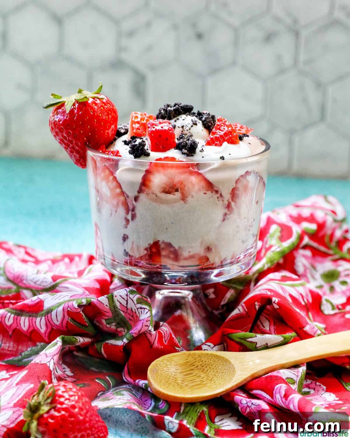 High-Protein Chocolate Dream Parfait 2 High protein chocolate parfait with berries and a wooden spoon on a red napkin.