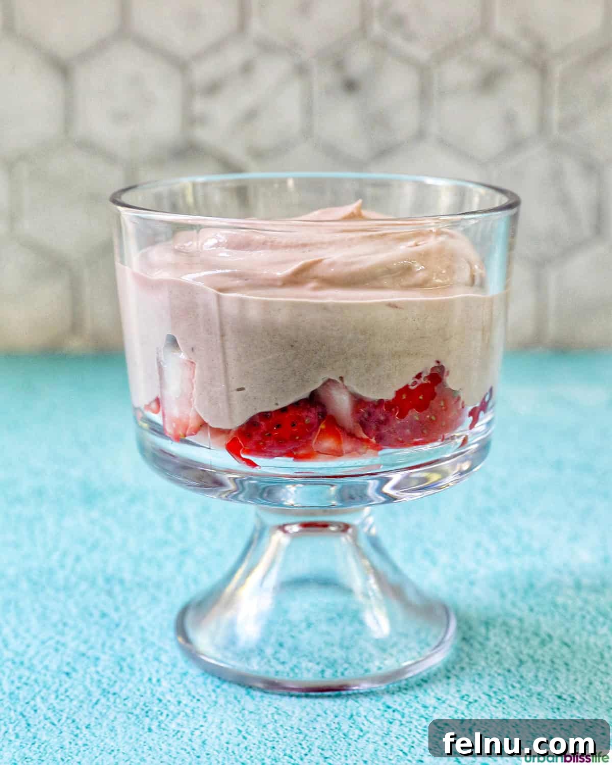 High-Protein Chocolate Dream Parfait 8 Chocolate parfait added to a bowl of strawberries, creating the first layer.