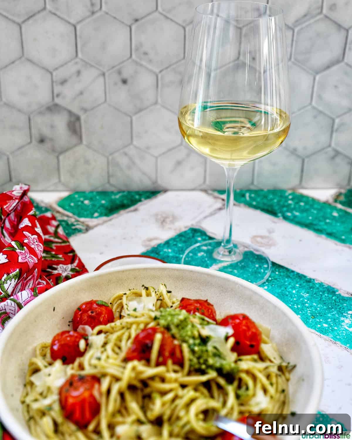 Vibrant Cherry Tomato Pesto Pasta 12 bowl of cherry tomato and pesto pasta with a glass of white wine.