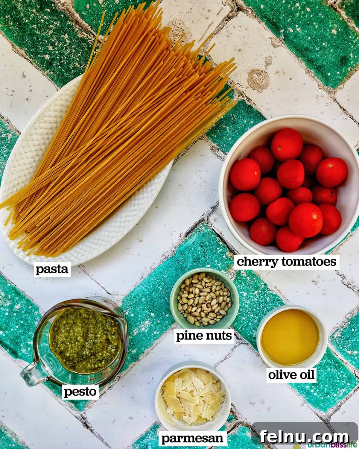 Vibrant Cherry Tomato Pesto Pasta 4 ingredients to make bowl of cherry tomato and pesto pasta.