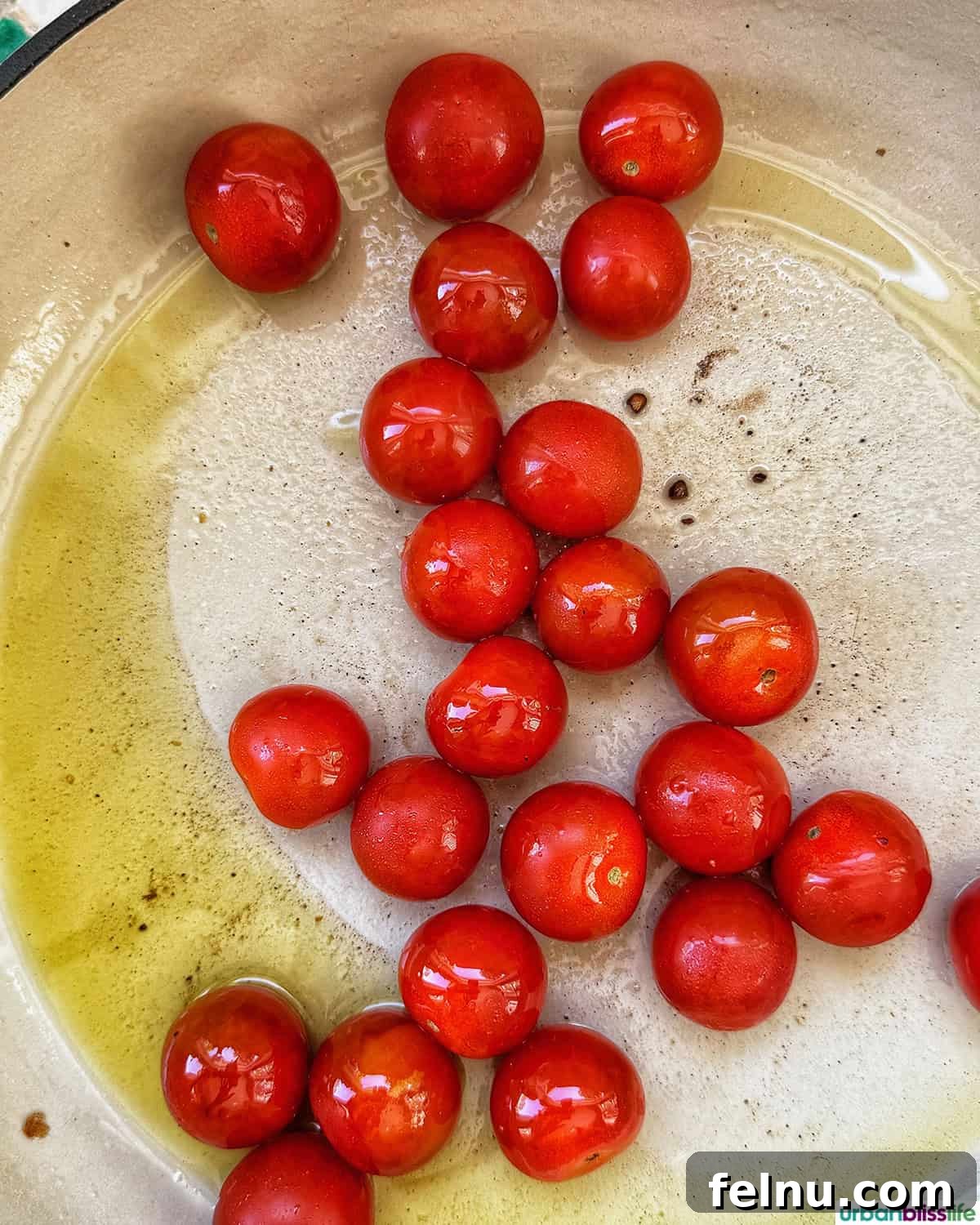 Vibrant Cherry Tomato Pesto Pasta 6 cherry tomatoes in a skillet.