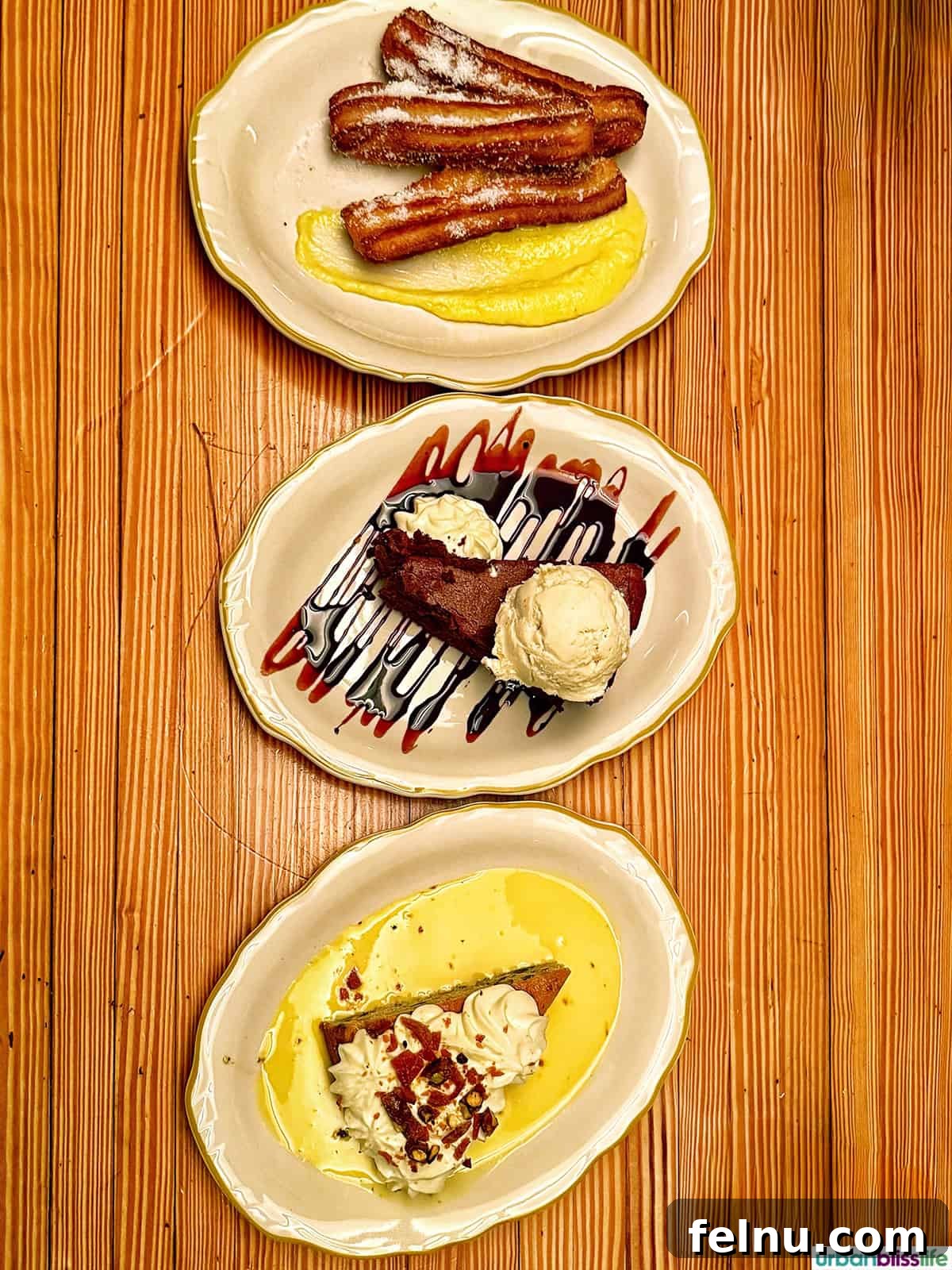 Montreal's Culinary Hotspots 13 Three delicious desserts on plates on a wood table at Papito, showcasing the restaurant's sweet offerings.