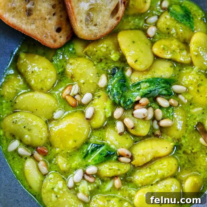 bowl of pesto beans with side of crostini.