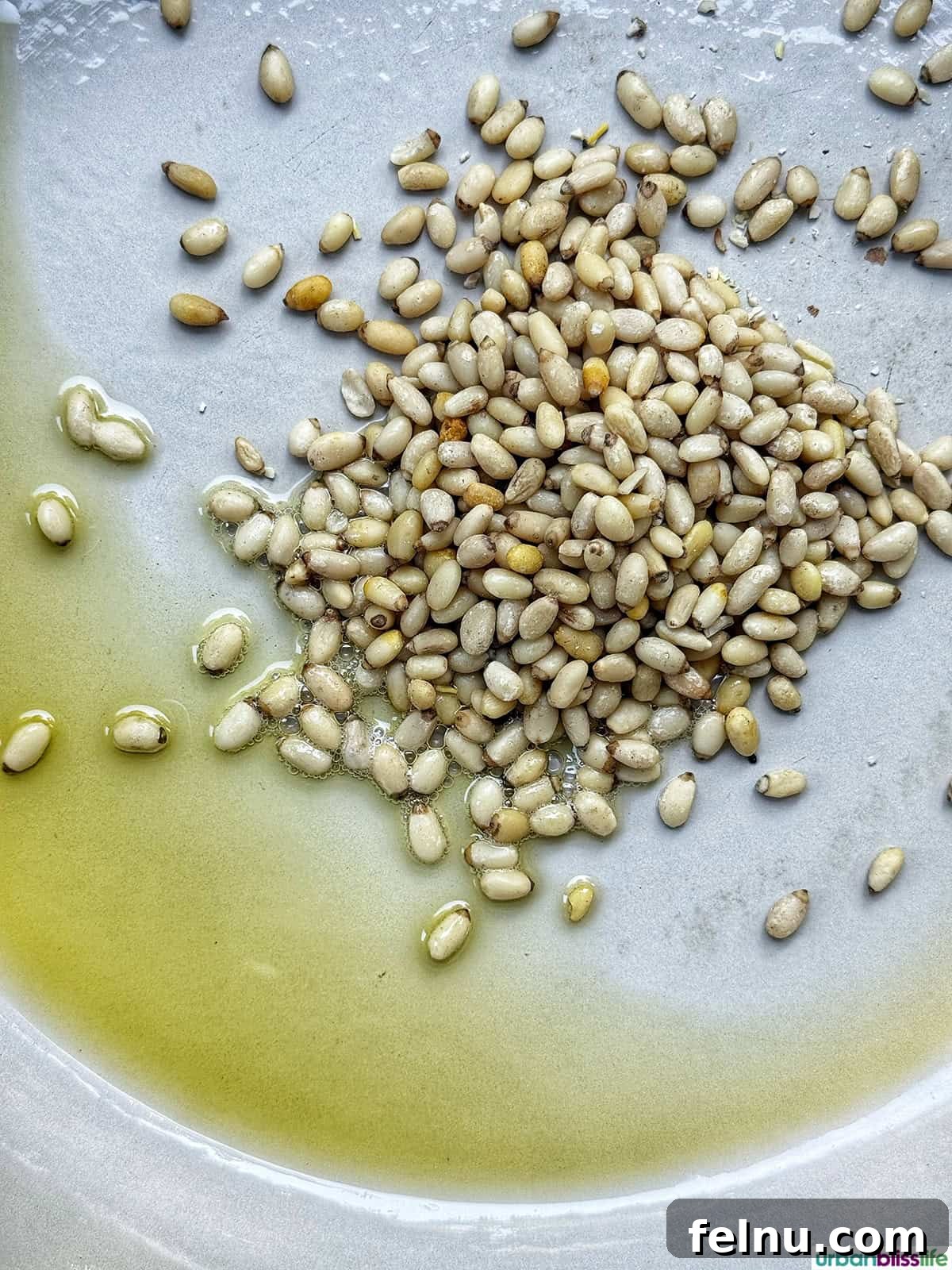 pine nuts in olive oil in a large pan. 