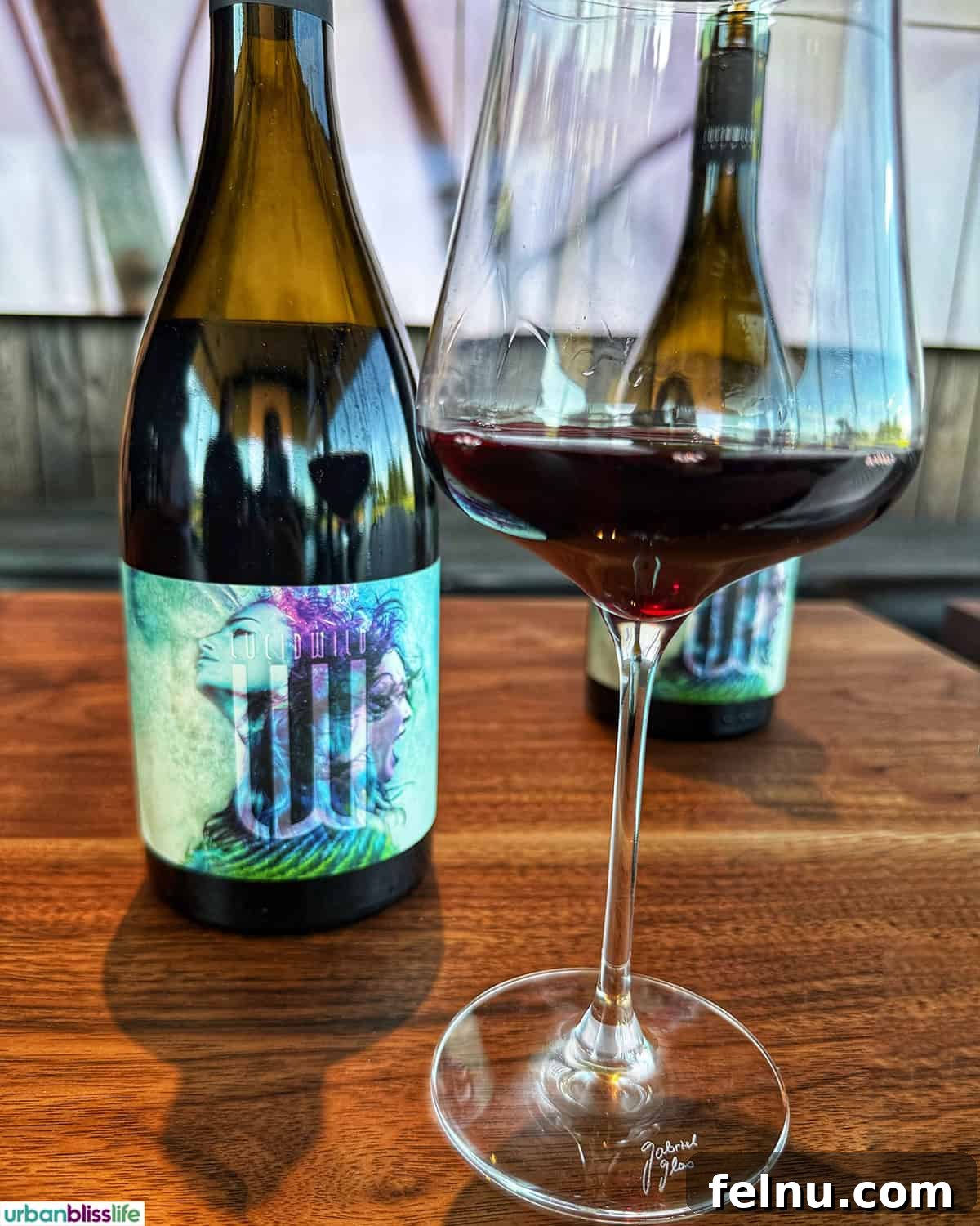 LucidWild Properties 15 Bottle and glass of LucidWild Fusion pinot noir