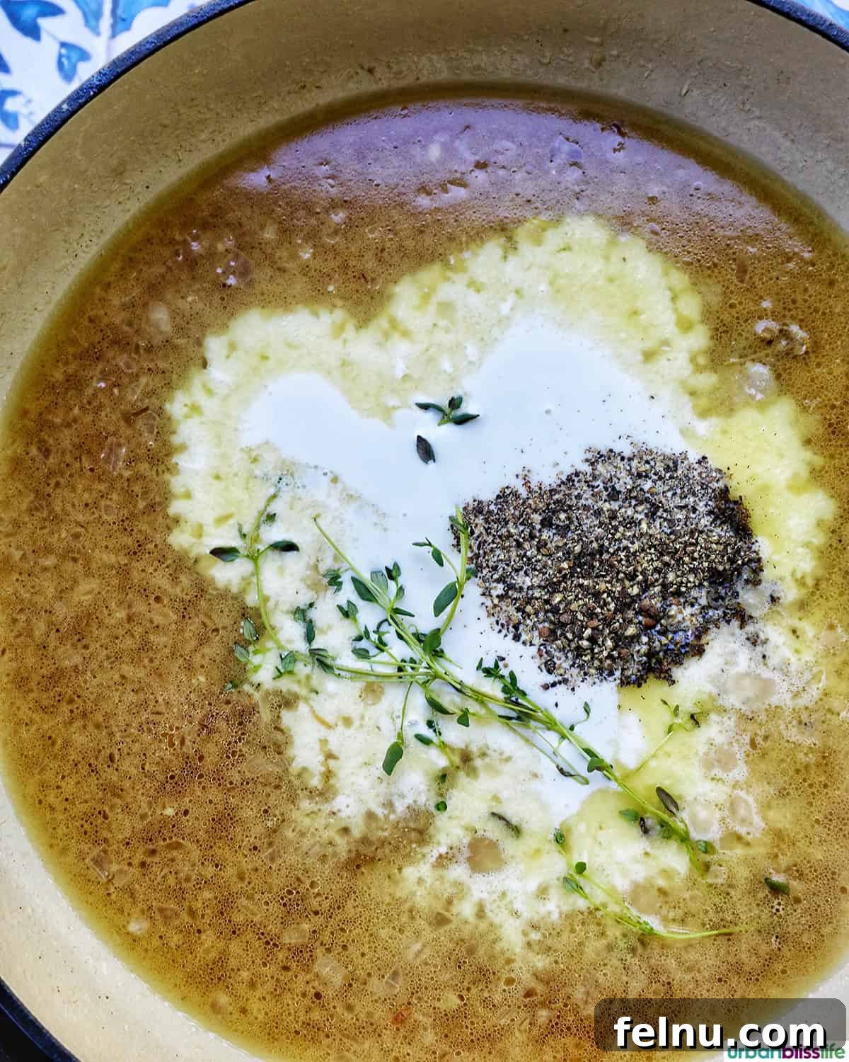 Rich Brandy Peppercorn Chicken 11 Chicken broth, heavy cream, cracked peppercorns, and fresh thyme sprigs simmering together in the skillet to form the sauce base.