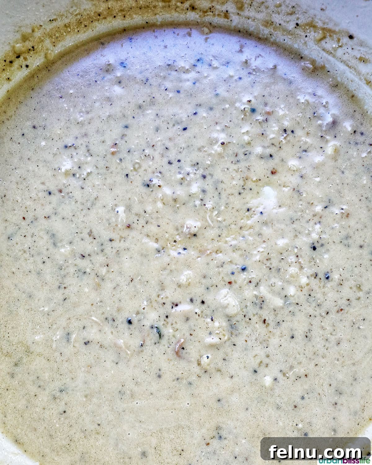 Rich Brandy Peppercorn Chicken 14 The peppercorn sauce simmering and reducing to a perfect, rich consistency in the pan.