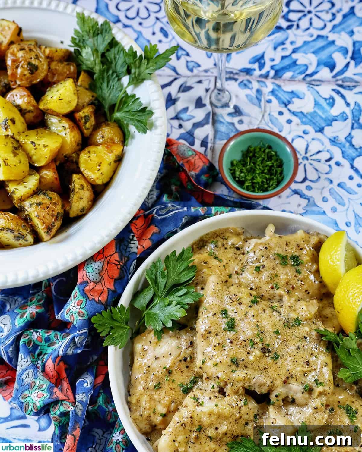 Rich Brandy Peppercorn Chicken 16 A beautifully presented meal of Chicken au Poivre alongside a bowl of herby roasted potatoes and a glass of white wine, creating an inviting dinner scene.