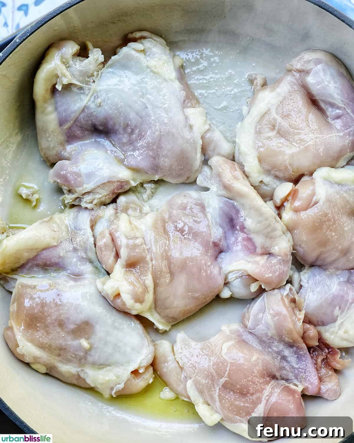 Rich Brandy Peppercorn Chicken 7 Chicken thighs sizzling and browning in a hot skillet with olive oil.